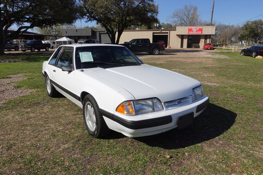 1990 White foxbody coupe, notchback, 3/4 angle shot from passenger side